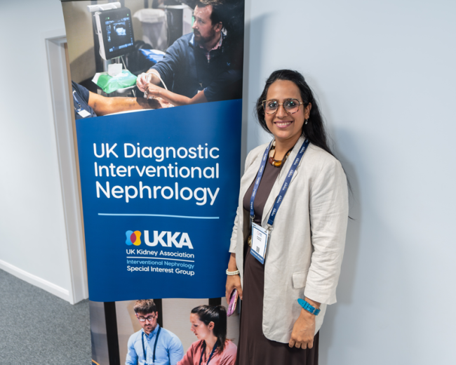 Delegate stands with a banner showing the UK Diagnostic Interventional Nephrology logo